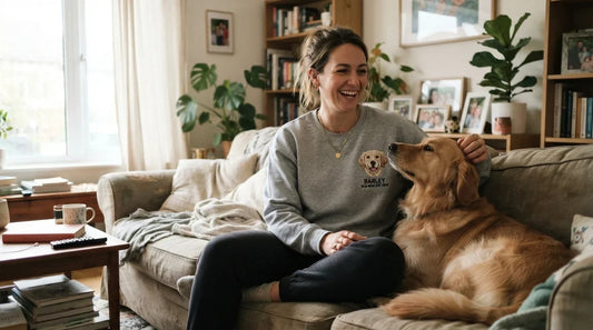 Dog mom wearing custom pet embroidered sweatshirt at home.