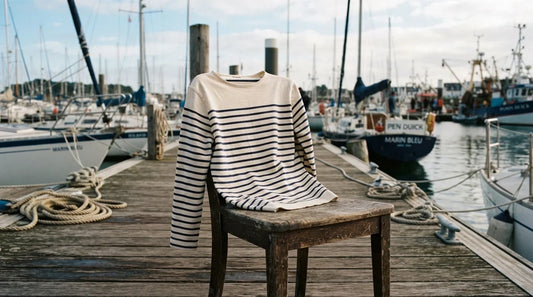 Breton navy and white striped shirt on harbor dock chair.