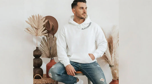 Man wearing white custom embroidered hoodie with Roman numerals