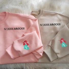 Customized Roman numeral embroidered sweatshirts for couples, with the couple’s names embroidered on the cuffs. - Tiuous